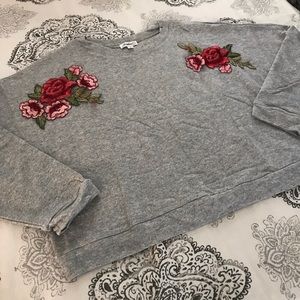 Gray crew neck sweatshirt with rose flower detail